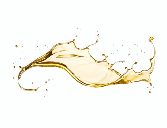Golden liquid splash isolated on white background, dynamic oil or syrup flow, Come see us at Awaken, Franklin, Tennessee