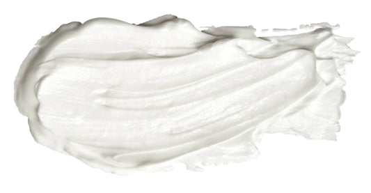 White creamy skincare or body lotion smear texture on white background. Come see us at Awaken, Franklin, Tennessee