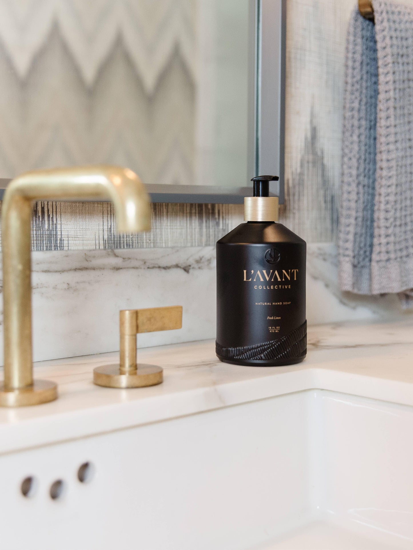 L'AVANT Collective natural hand soap on marble bathroom counter with gold faucet, Come see us at Awaken, Franklin, Tennessee