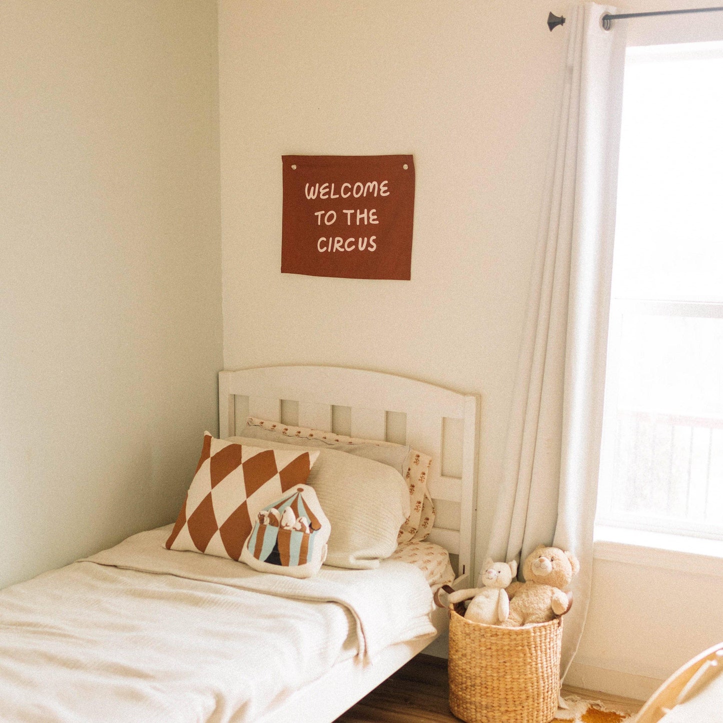 Cozy kids bedroom with circus decor, plush toys, and 'Welcome to the Circus' sign. Come see us at Awaken, Franklin, Tennessee.