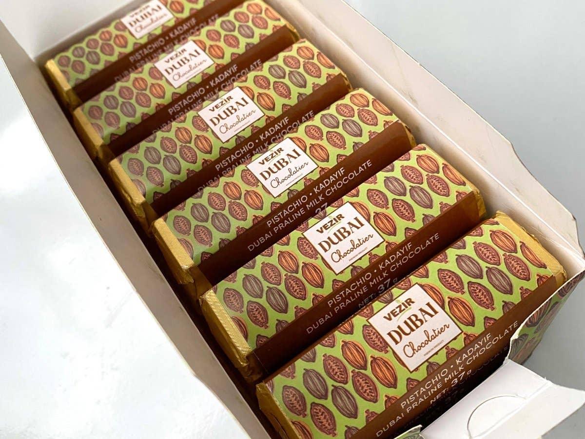 Box of Vezir Dubai Chocolatier pistachio kadayif praline milk chocolate bars with decorative packaging. Come see us at Awaken, Franklin, Tennessee