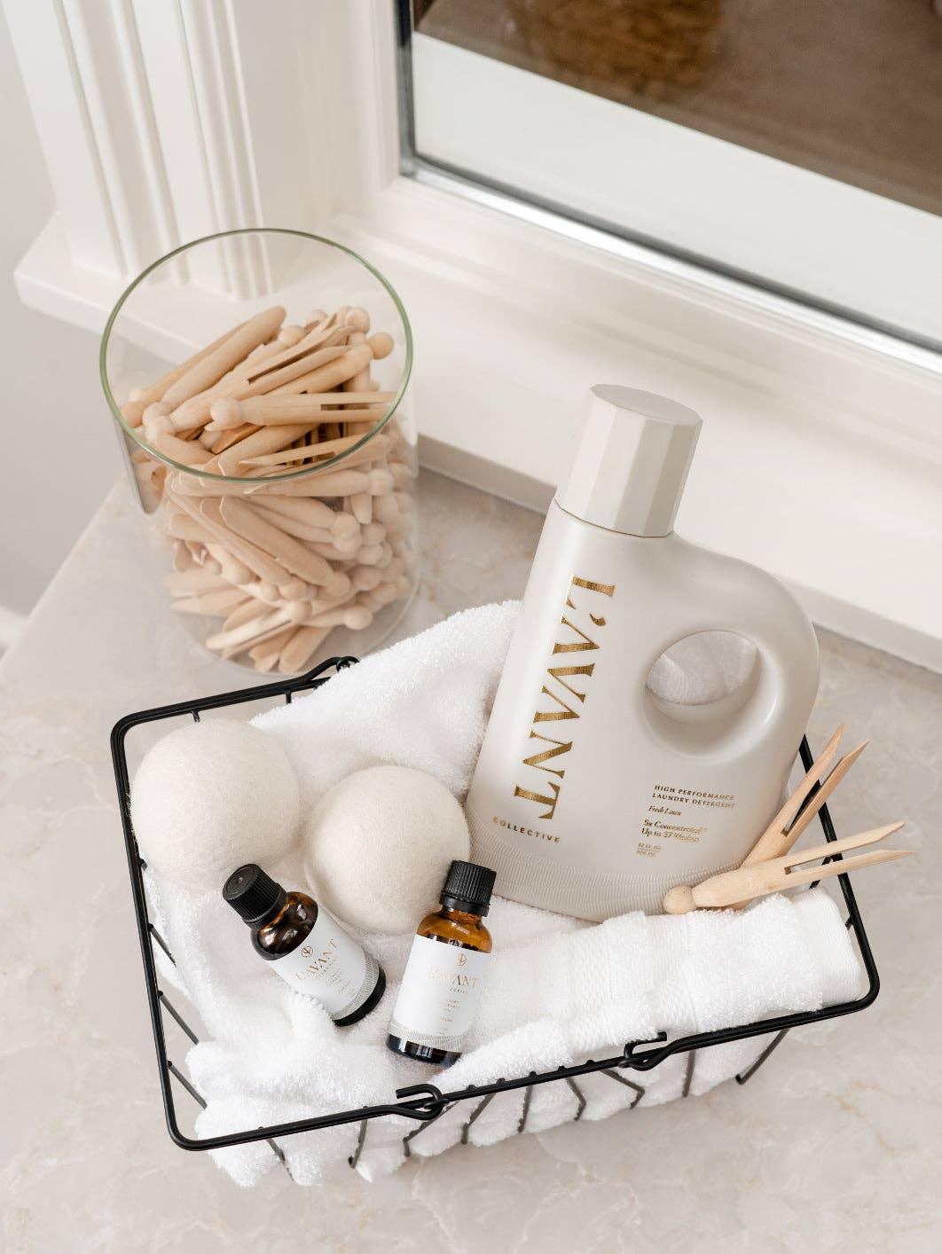 Lavant laundry products and wool dryer balls in a wire basket, Come see us at Awaken, Franklin, Tennessee.