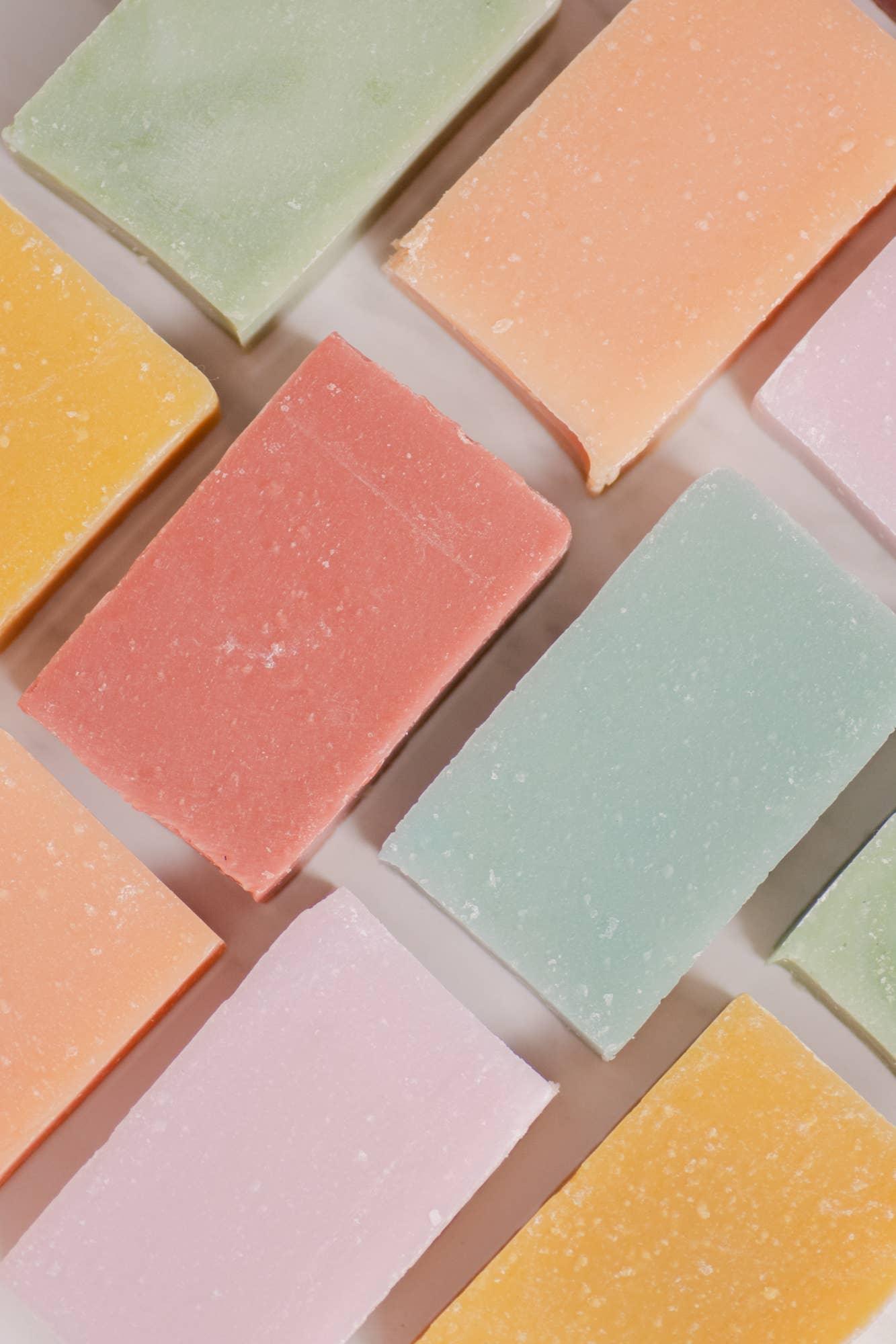 Colorful rectangular soap bars arranged on a white surface, pastel shades included. Come see us at Awaken, Franklin, Tennessee