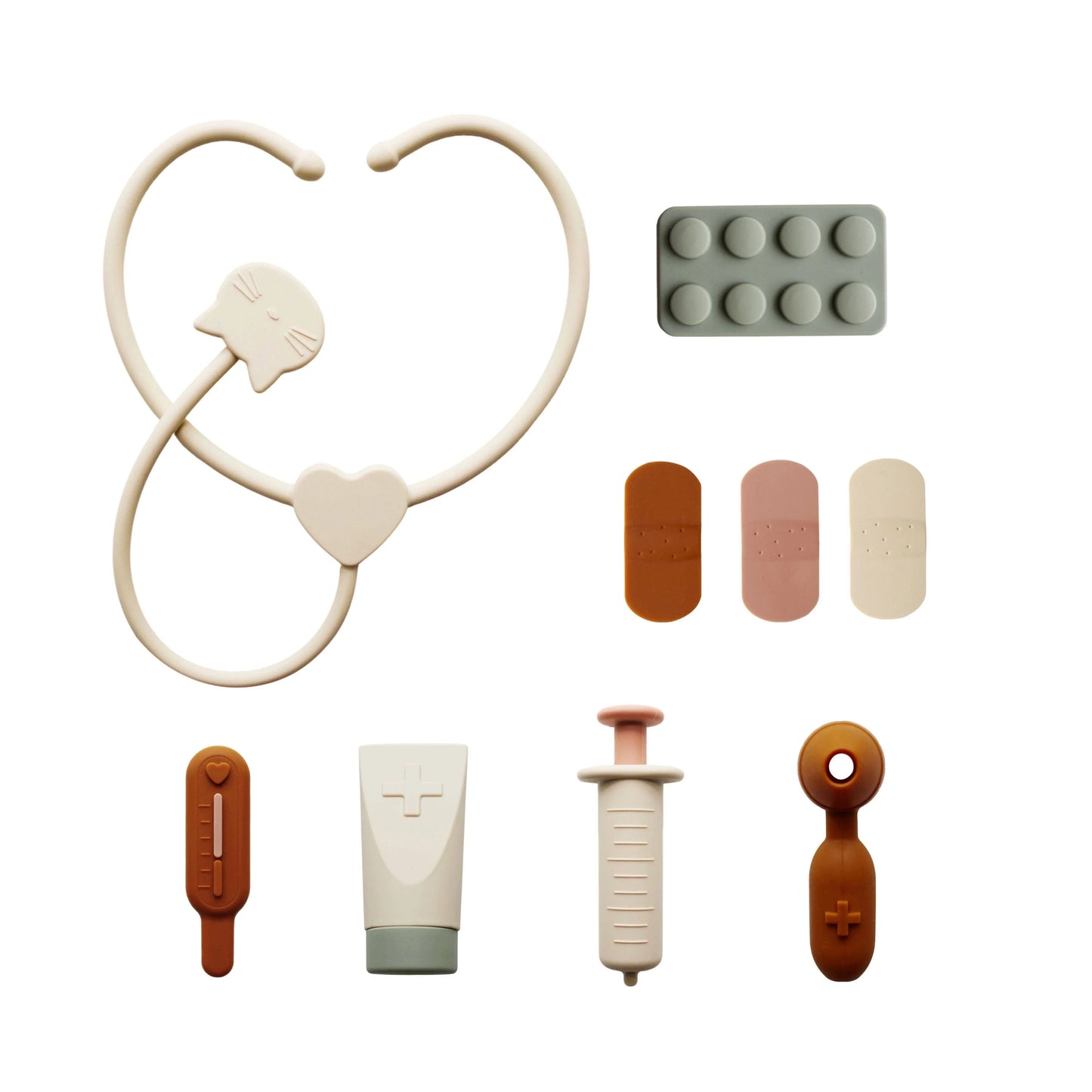 Toy medical kit with stethoscope, pills, bandages, syringe, and thermometer in neutral tones. Come see us at Awaken, Franklin, Tennessee