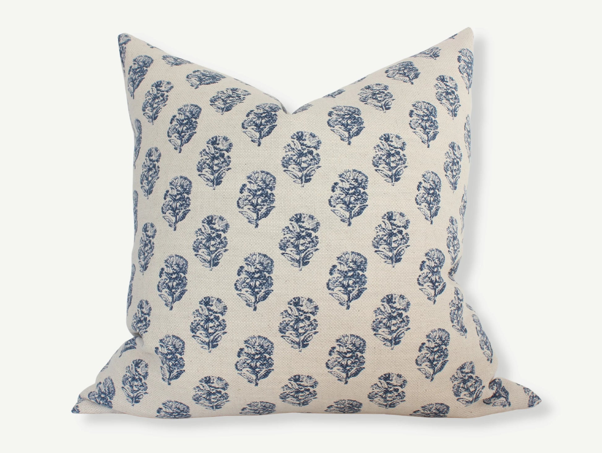 Decorative cream pillow with blue floral pattern, soft fabric texture, Come see us at Awaken, Franklin, Tennessee