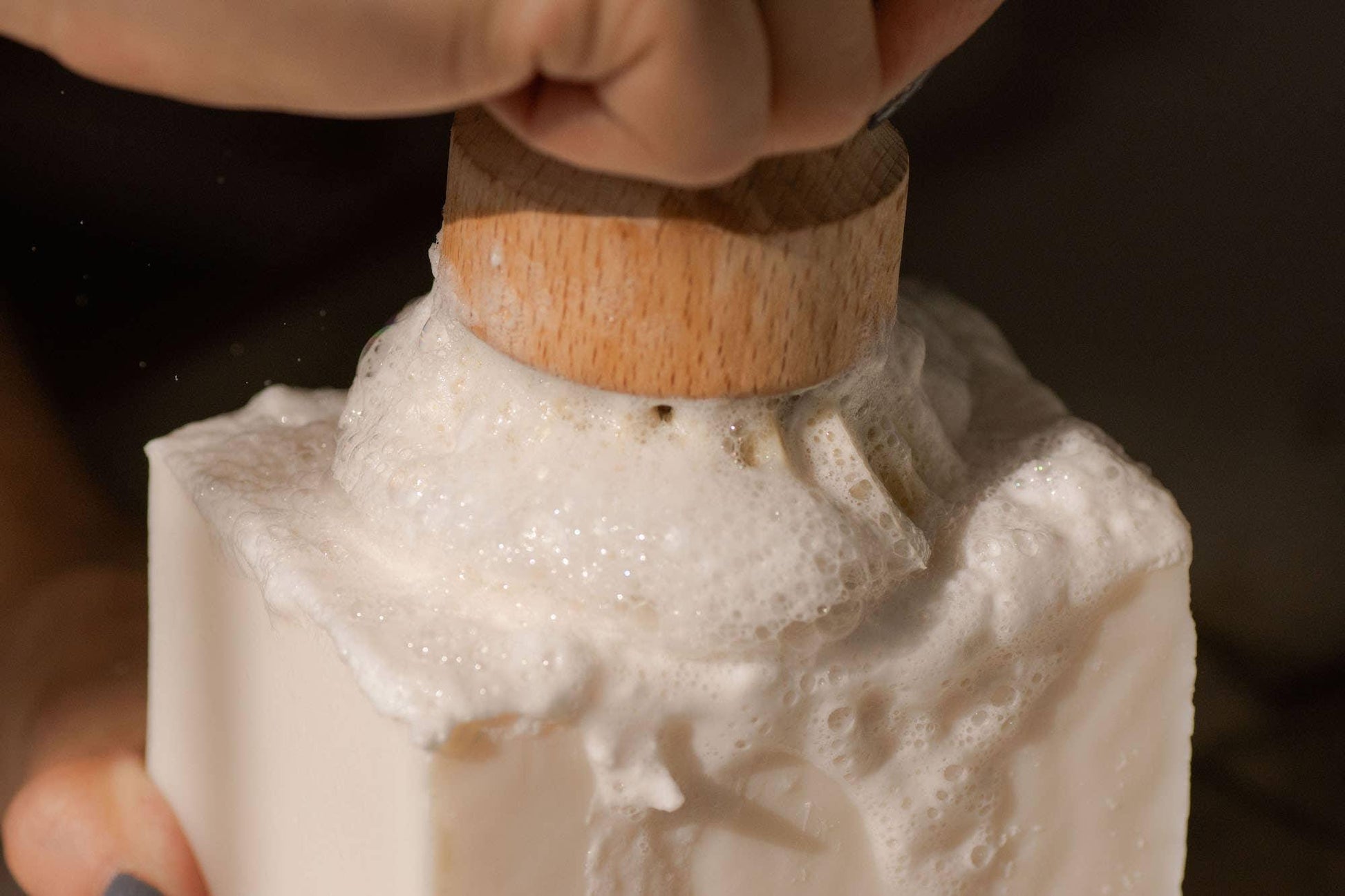 Wooden brush creating foam on white soap bar, skincare cleansing routine, Come see us at Awaken, Franklin, Tennessee