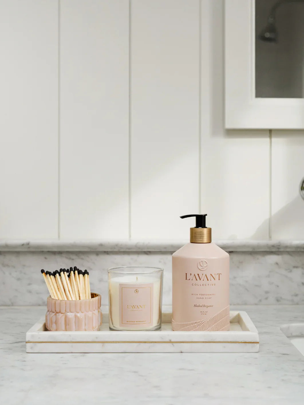 L'AVANT Collective hand soap, candle, and matches on marble tray in bathroom. Come see us at Awaken, Franklin, Tennessee.