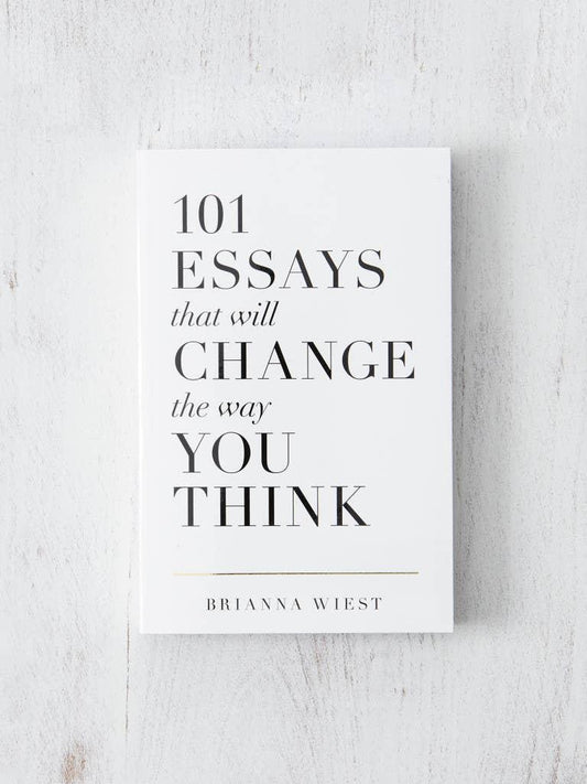 Book titled '101 Essays That Will Change The Way You Think' by Brianna Wiest on a white textured surface. Come see us at Awaken, Franklin, Tennessee