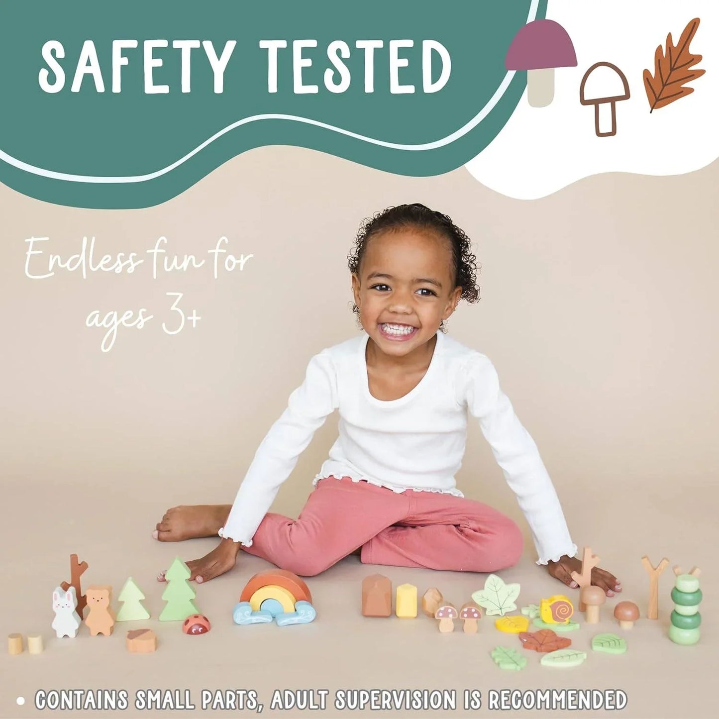 Smiling child playing with colorful wooden toys on beige background, safety tested and fun for ages 3+. Come see us at Awaken, Franklin, Tennessee