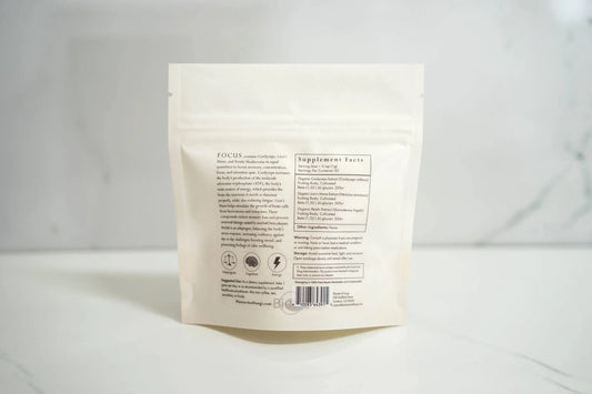 Back of white supplement bag with focus blend ingredients and nutrition facts on marble surface. Come see us at Awaken, Franklin, Tennessee