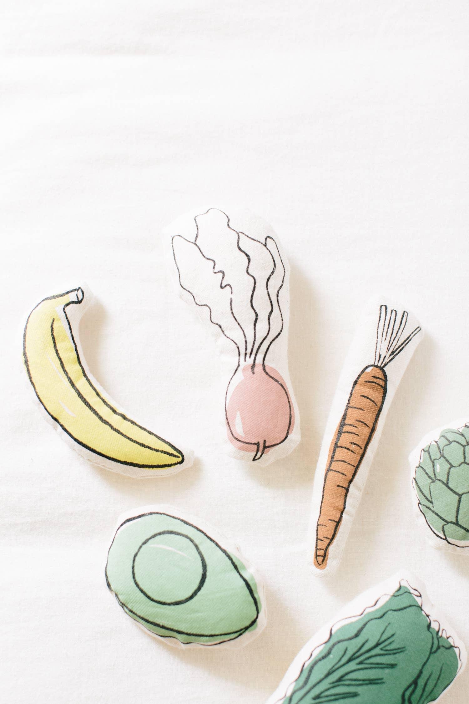 Plush fruits and vegetables on white fabric, Come see us at Awaken, Franklin, Tennessee