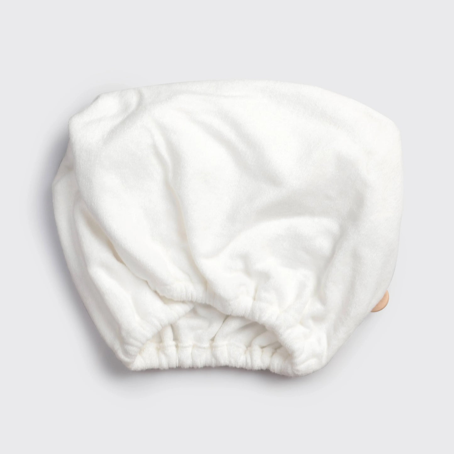 White terry cloth shower cap on gray background, Come see us at Awaken, Franklin, Tennessee