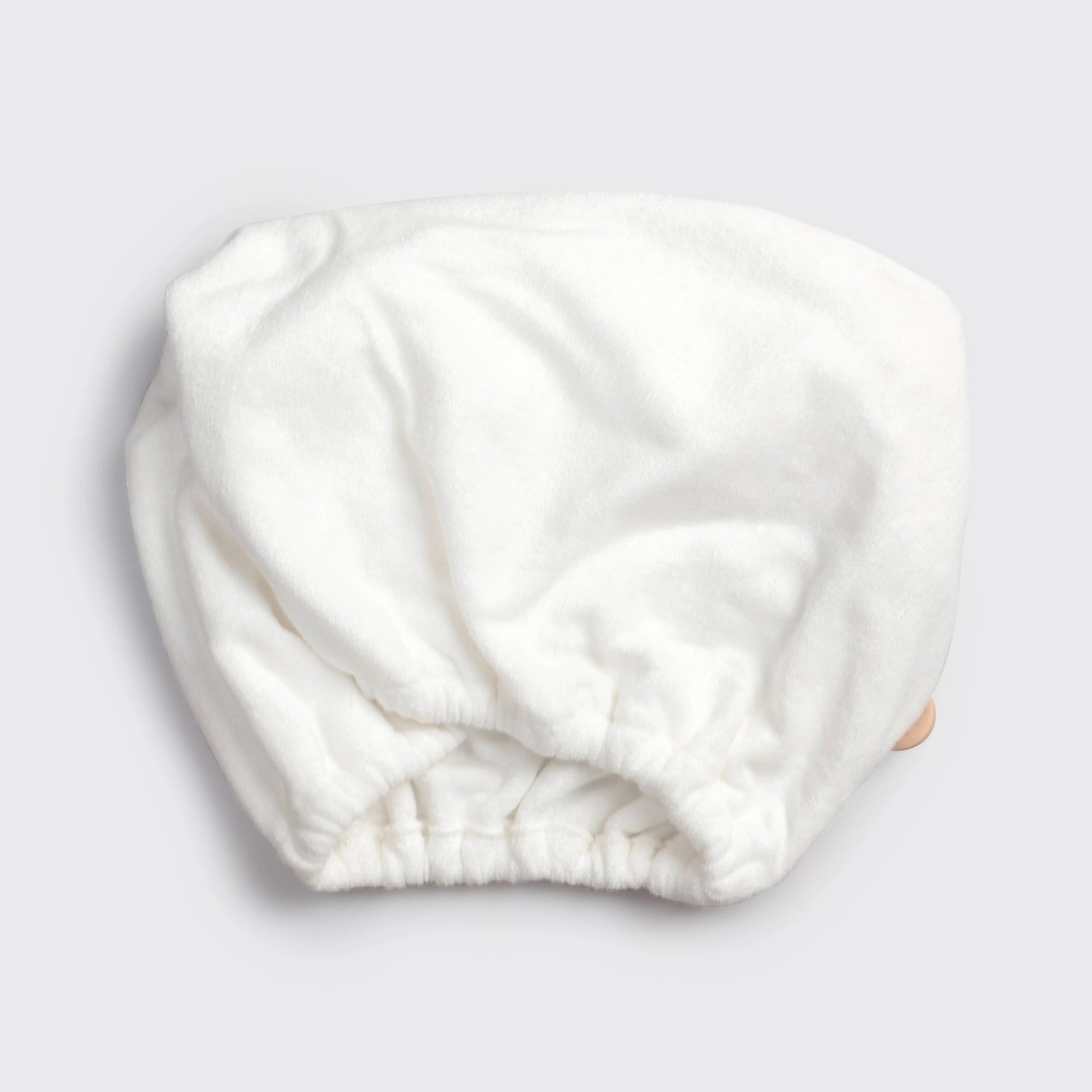 White terry cloth shower cap on gray background, Come see us at Awaken, Franklin, Tennessee