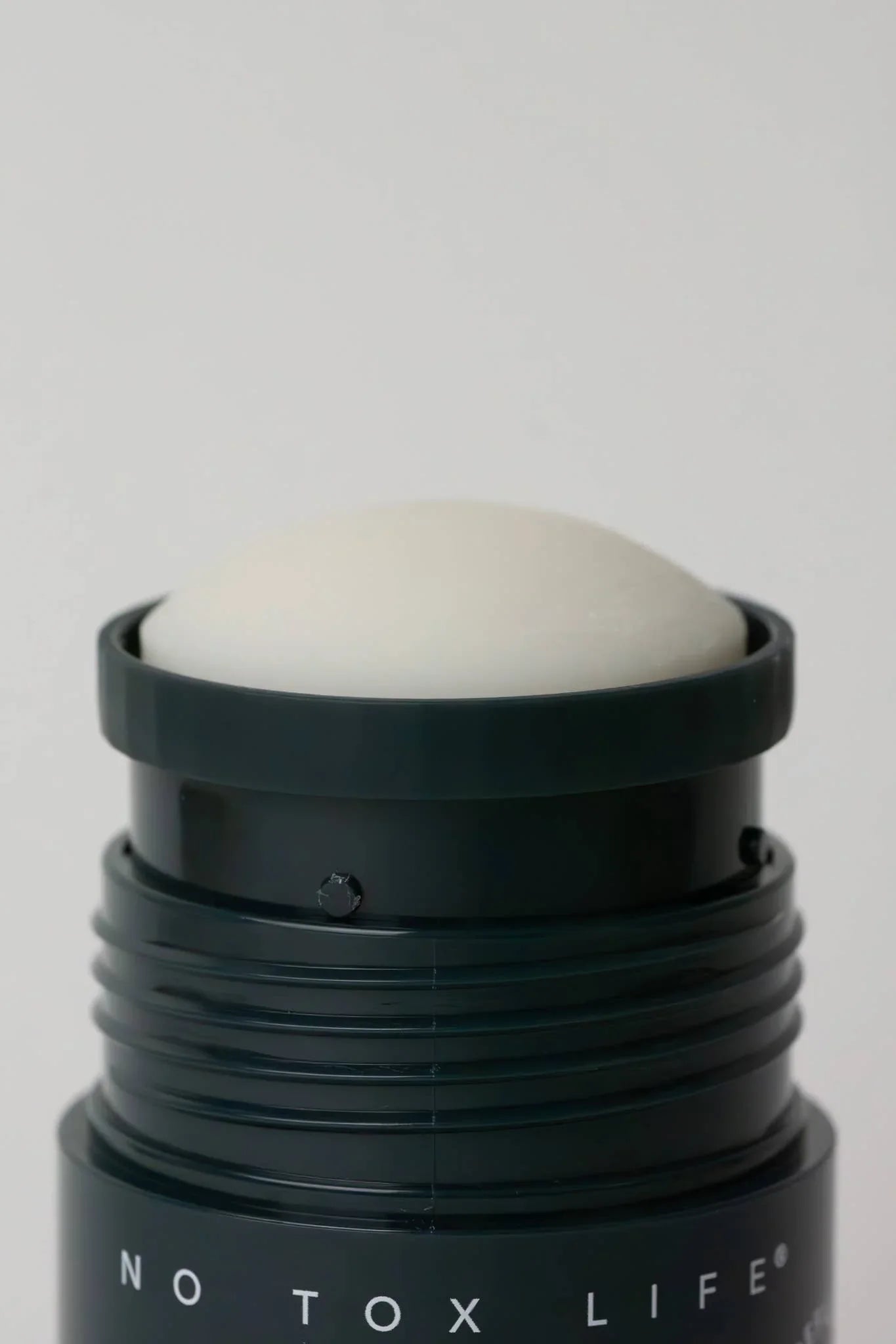 Close-up of No Tox Life deodorant stick with black container and white solid, Come see us at Awaken, Franklin, Tennessee