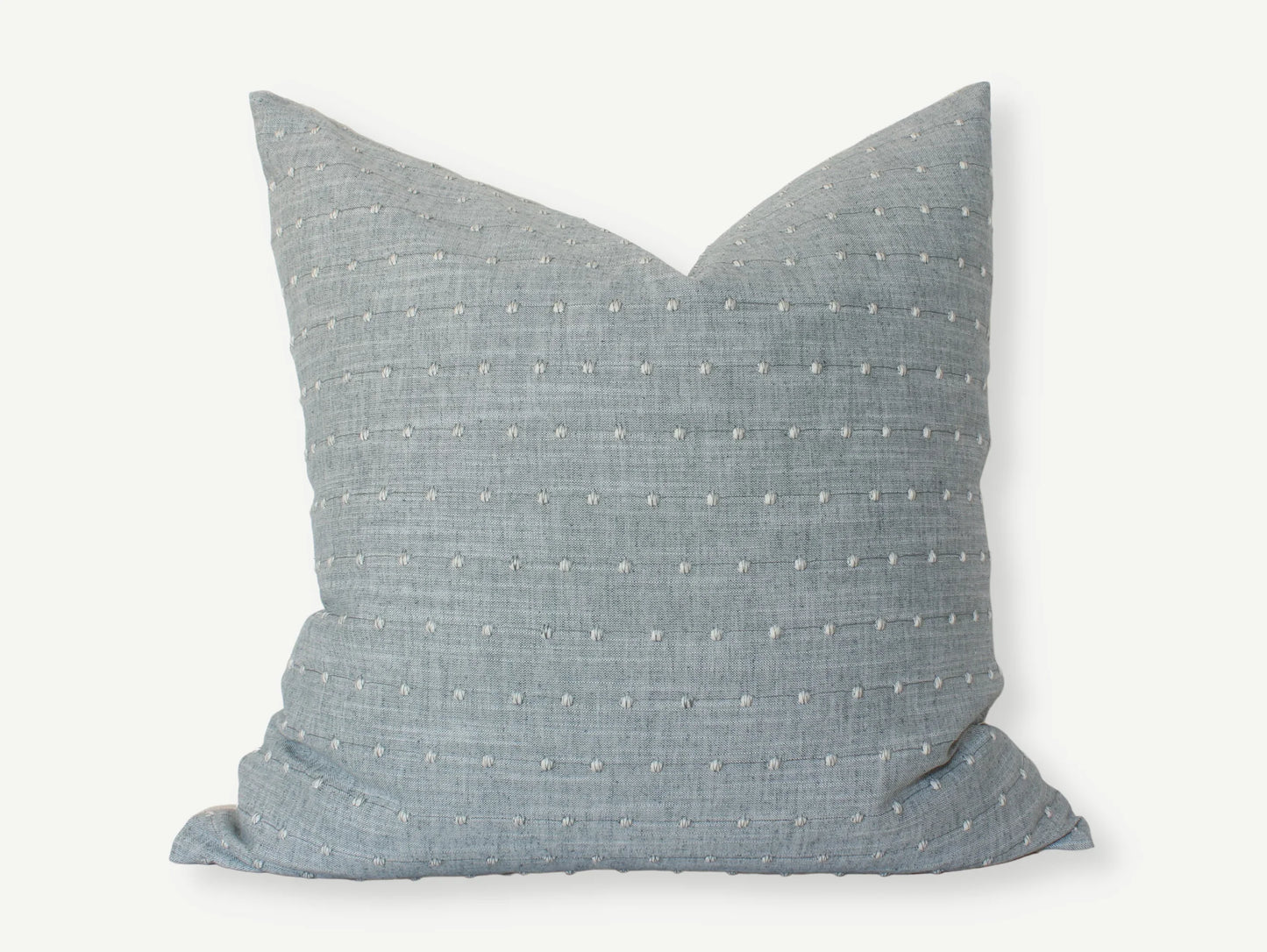 Blue textured square throw pillow with white stitched dots, cozy home decor. Come see us at Awaken, Franklin, Tennessee