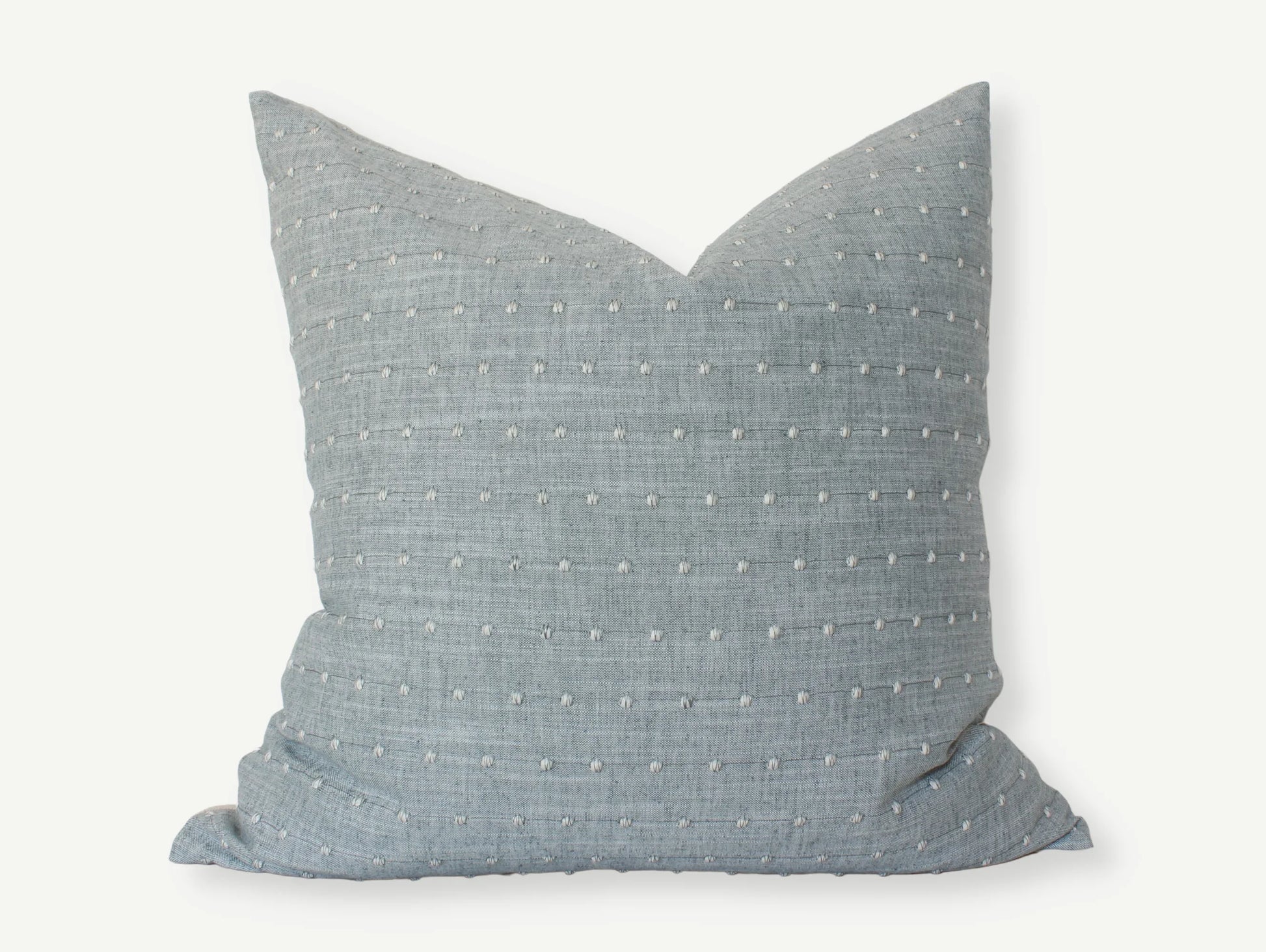 Blue textured square throw pillow with white stitched dots, cozy home decor. Come see us at Awaken, Franklin, Tennessee
