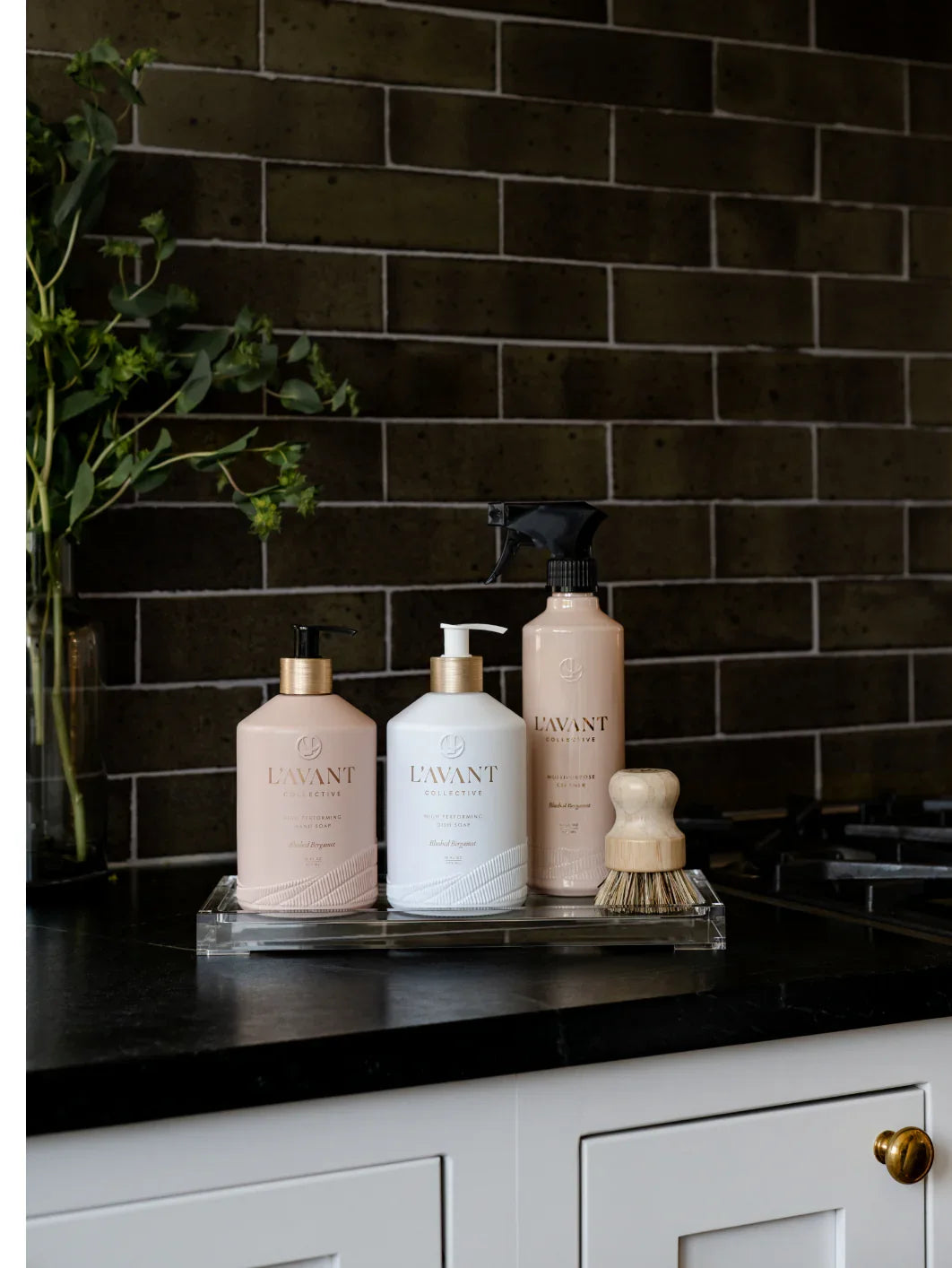 L'AVANT Collective cleaning products on kitchen counter with plant, Come see us at Awaken, Franklin, Tennessee
