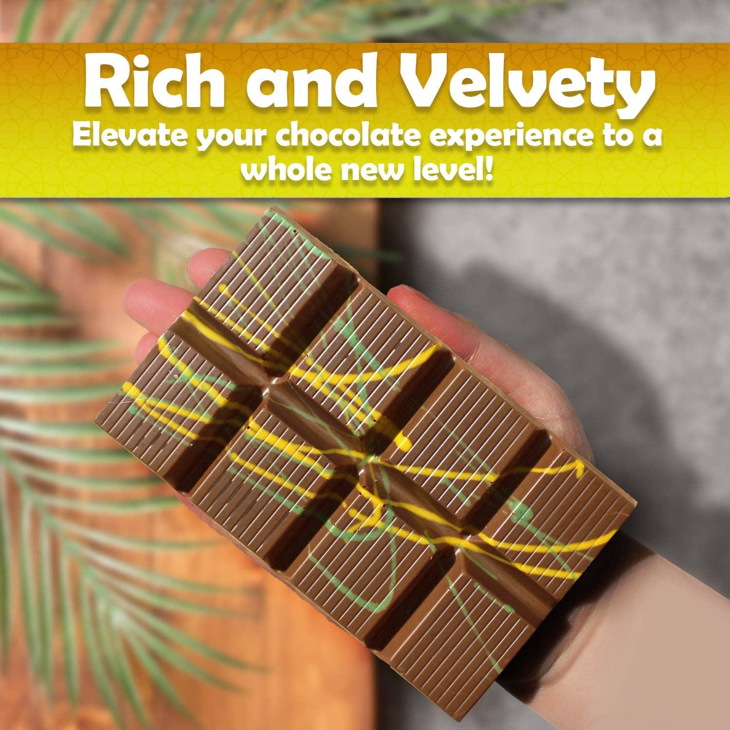 Hand holding chocolate bar with colorful drizzle, rich and velvety text, Come see us at Awaken, Franklin, Tennessee