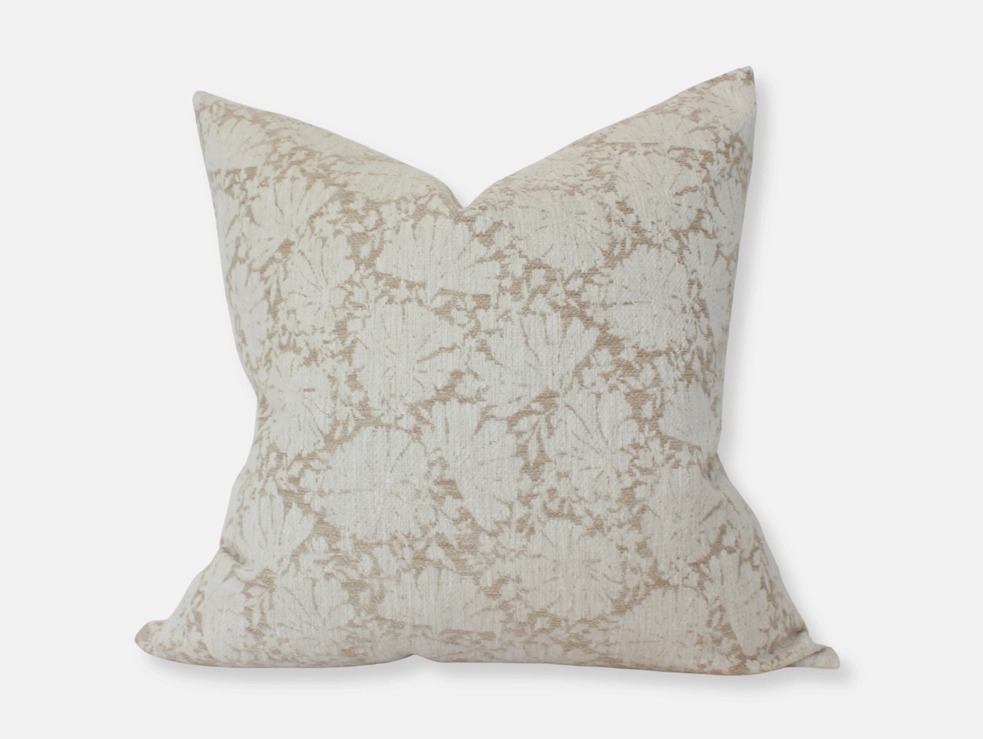 Beige floral patterned decorative throw pillow on white background. Come see us at Awaken, Franklin, Tennessee