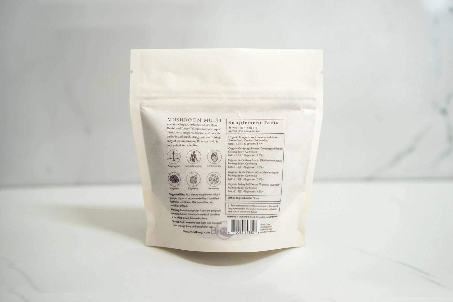 Back of Mushroom Multi supplement bag with ingredients and benefits listed on white marble surface, Come see us at Awaken, Franklin, Tennessee