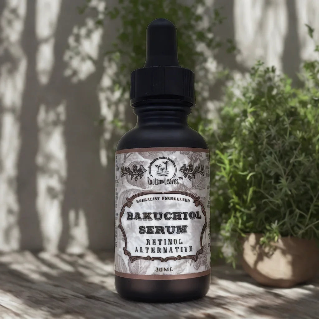 Roots and Leaves Bakuchiol Serum bottle on wooden table with plant background, natural skincare. Come see us at Awaken, Franklin, Tennessee