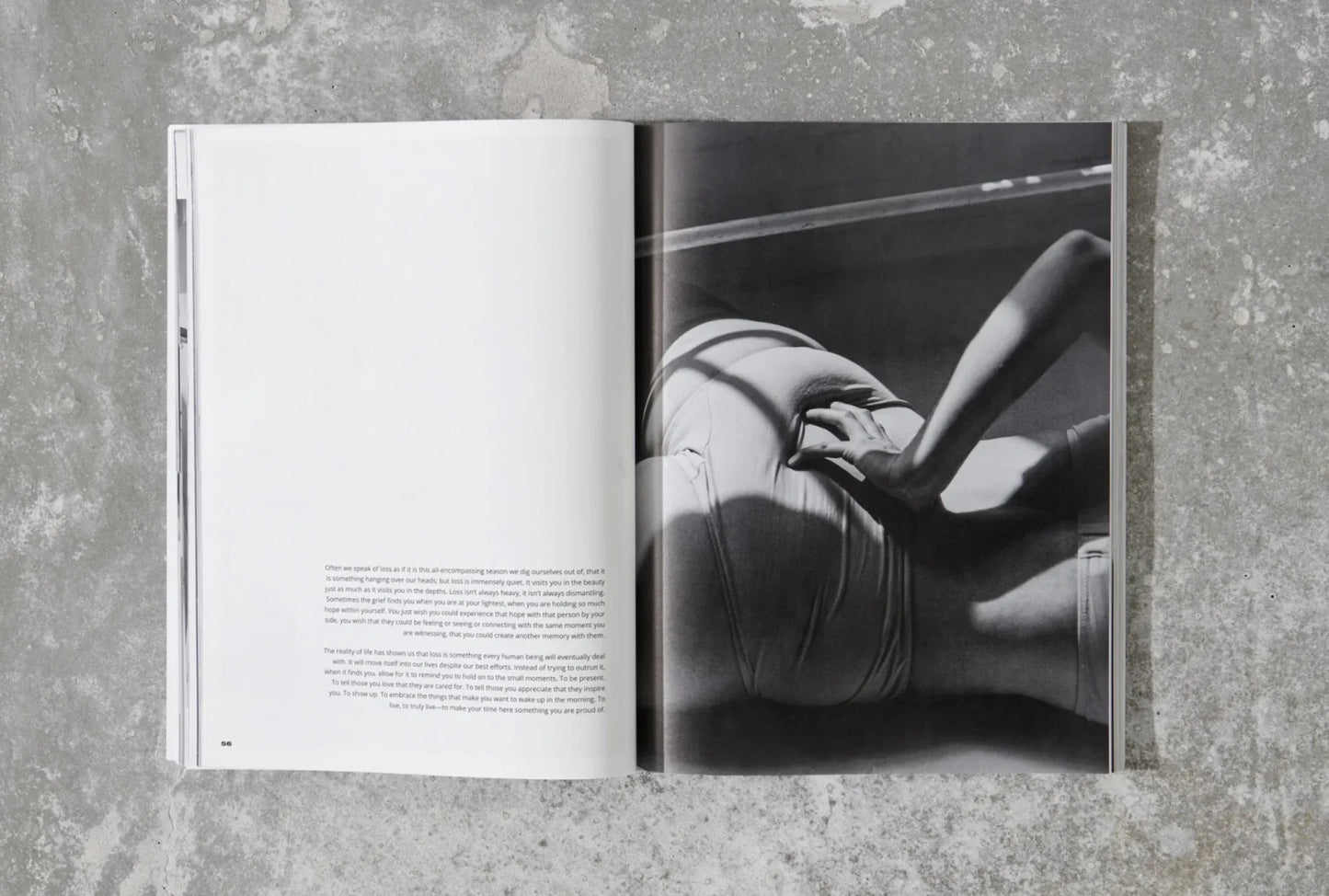 Black and white magazine spread featuring a seated person with hand on waist, on concrete floor. Come see us at Awaken, Franklin, Tennessee