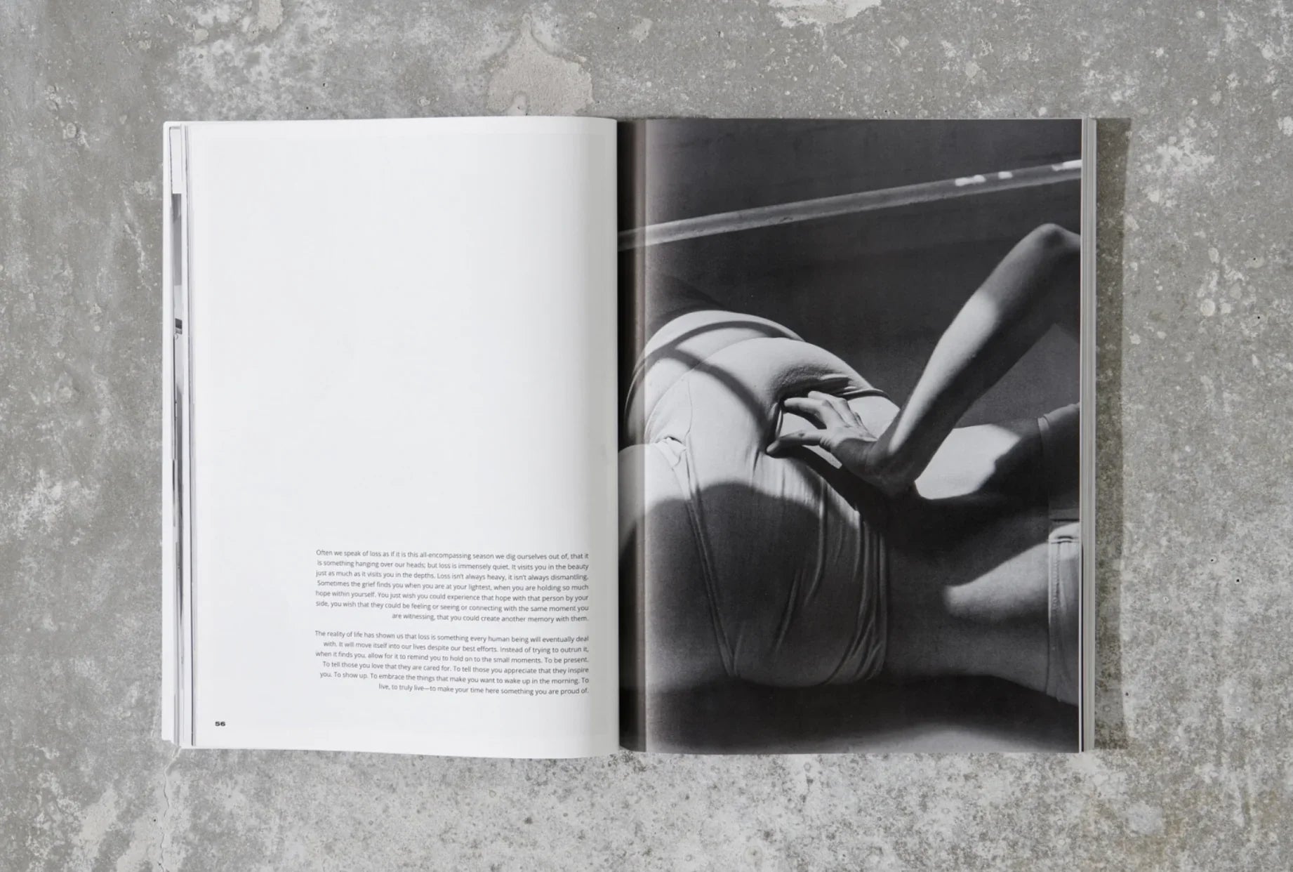 Black and white magazine spread featuring a seated person with hand on waist, on concrete floor. Come see us at Awaken, Franklin, Tennessee
