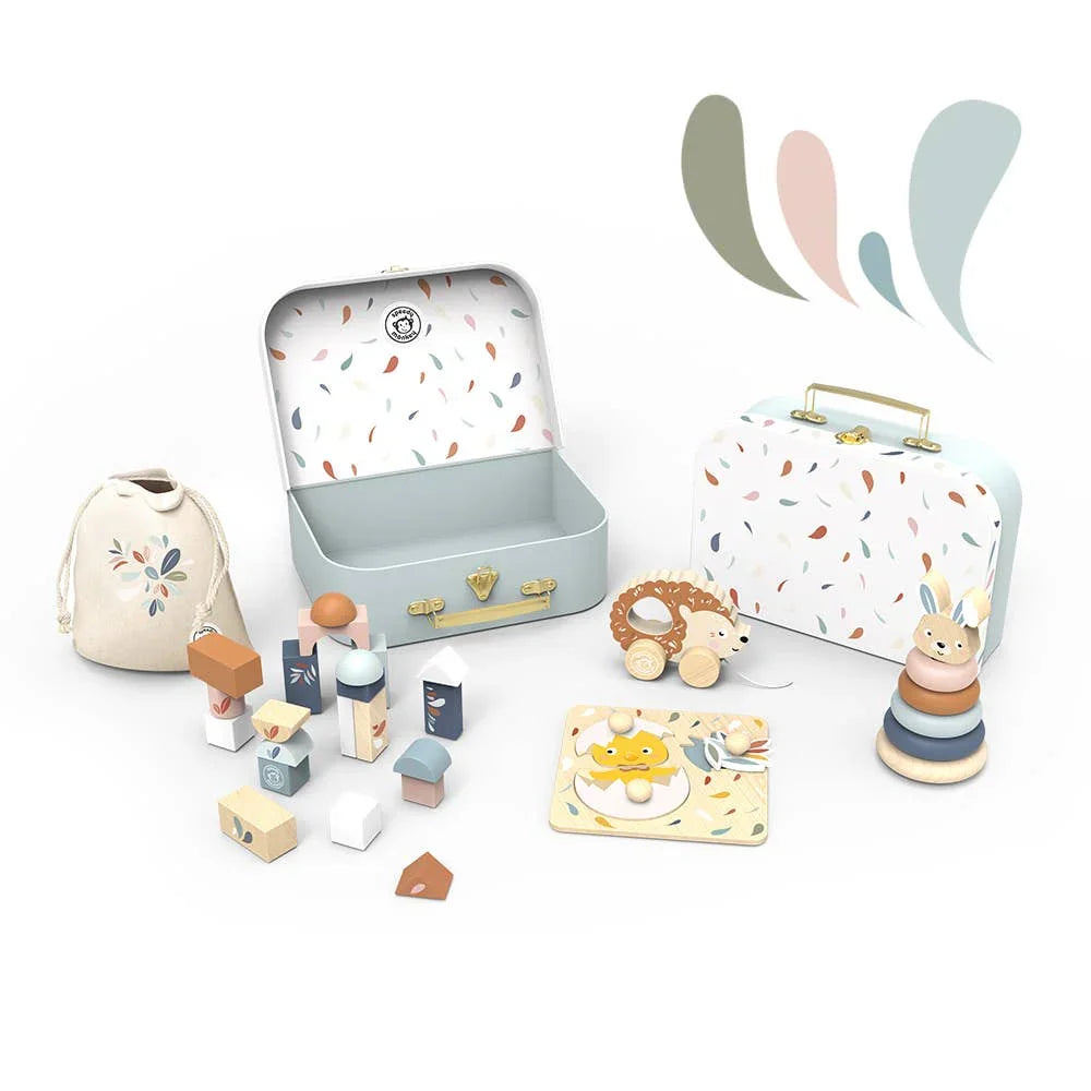Children's pastel wooden toy set with suitcase, stacking rings, pull-along hedgehog, and blocks. Come see us at Awaken, Franklin, Tennessee