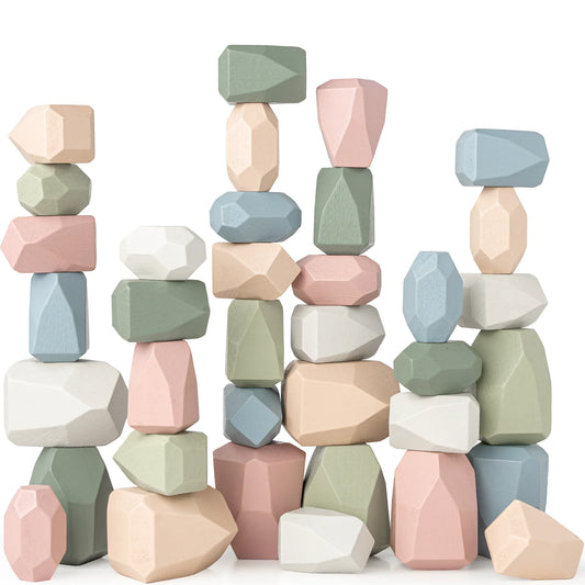 Stacked pastel wooden balancing stones in pink, blue, green, and white colors, geometric shapes. Come see us at Awaken, Franklin, Tennessee