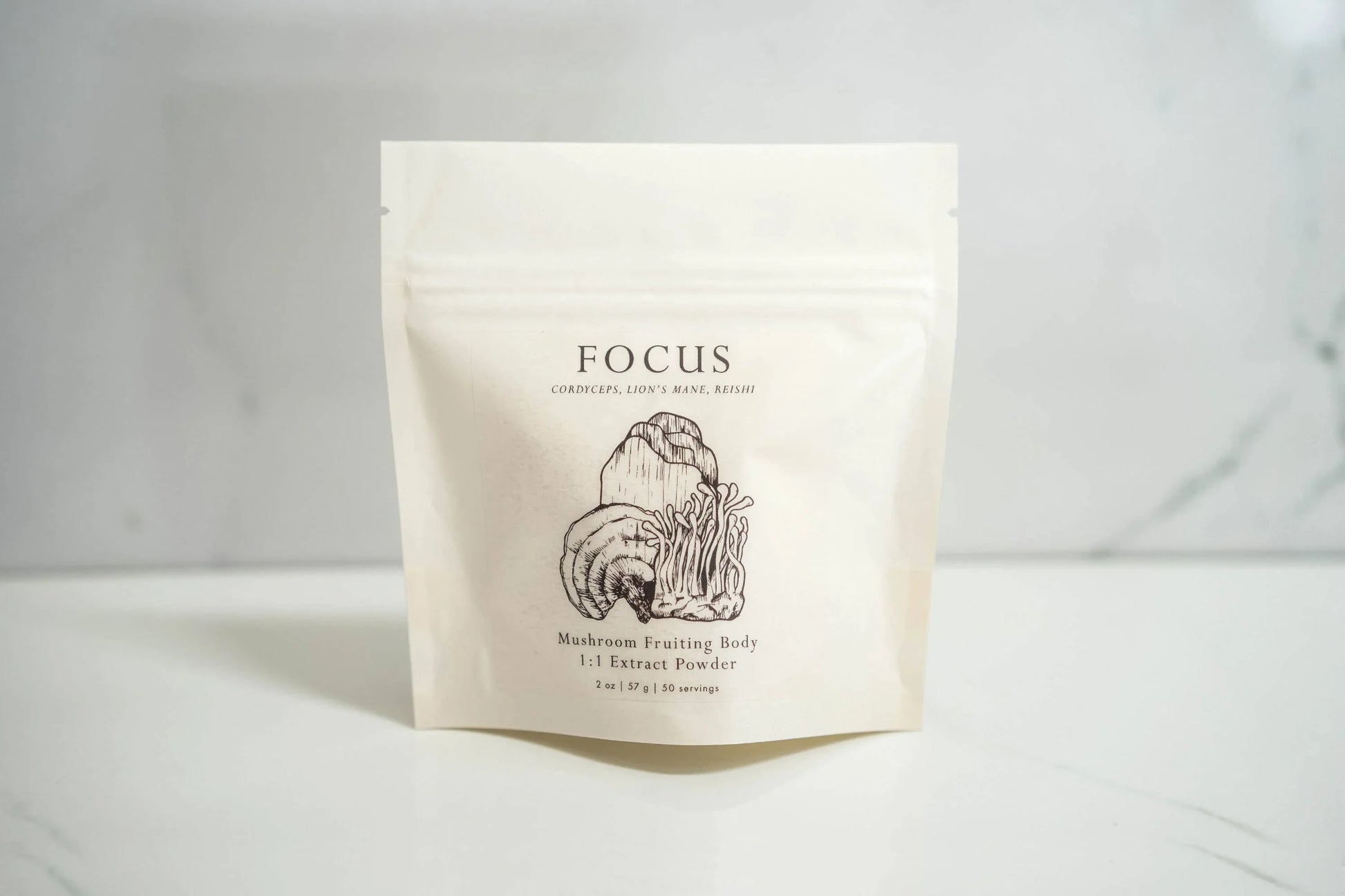 Focus mushroom extract powder package on white surface with mushroom illustrations; Come see us at Awaken, Franklin, Tennessee