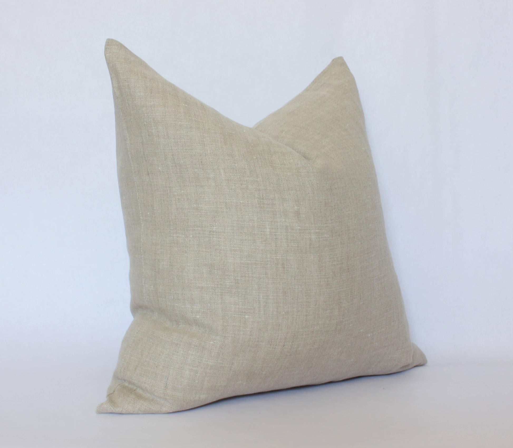 Beige textured linen throw pillow on white background, minimalist home decor, Come see us at Awaken, Franklin, Tennessee
