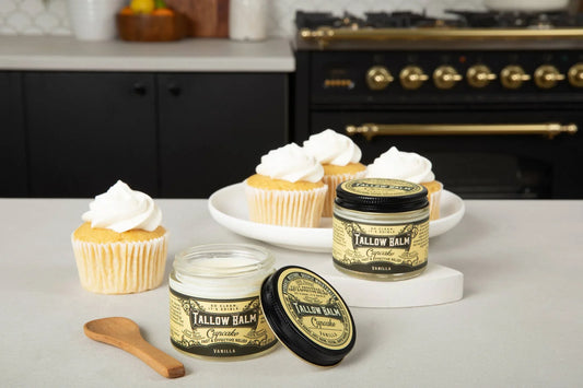 Vanilla Tallow Balm jars with cupcakes and wooden spoon on kitchen counter Come see us at Awaken, Franklin, Tennessee