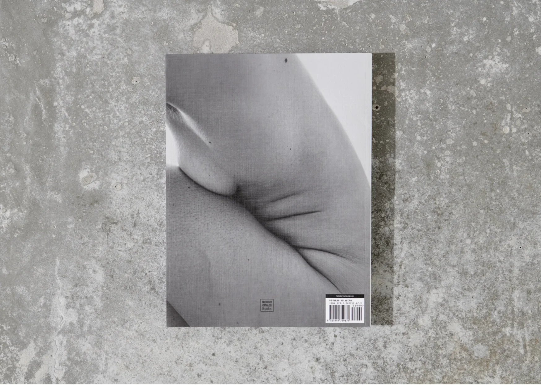 Book with black and white close-up photo on concrete surface, barcode and Thought Catalog logo visible, Come see us at Awaken, Franklin, Tennessee