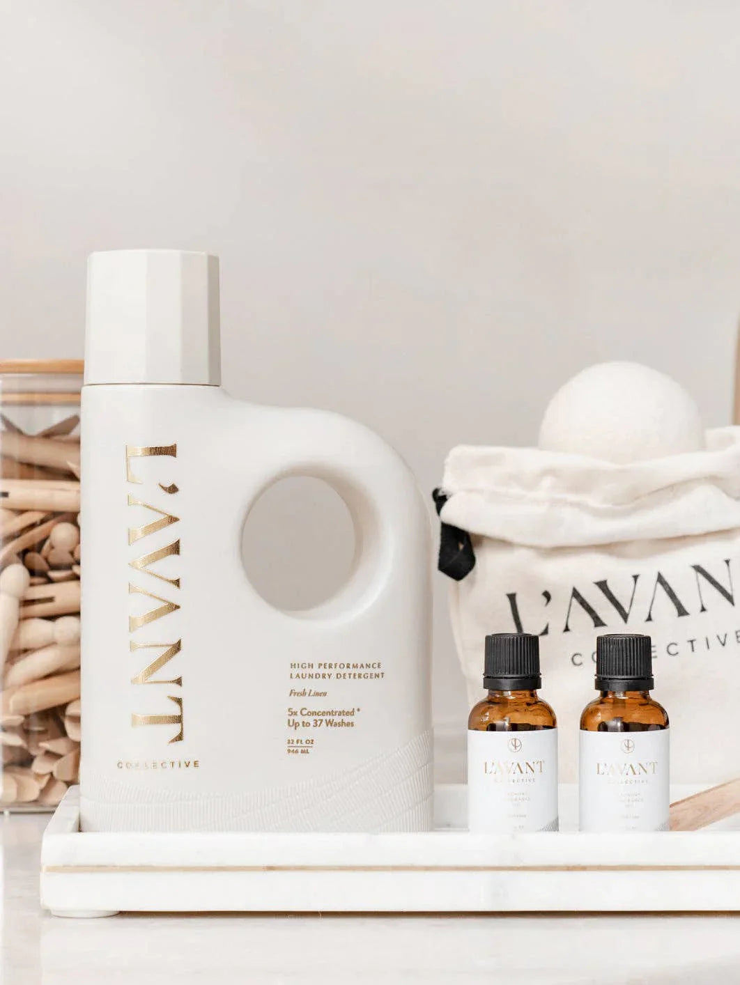 L'AVANT Collective laundry detergent, dryer balls, and essential oils on tray, Come see us at Awaken, Franklin, Tennessee
