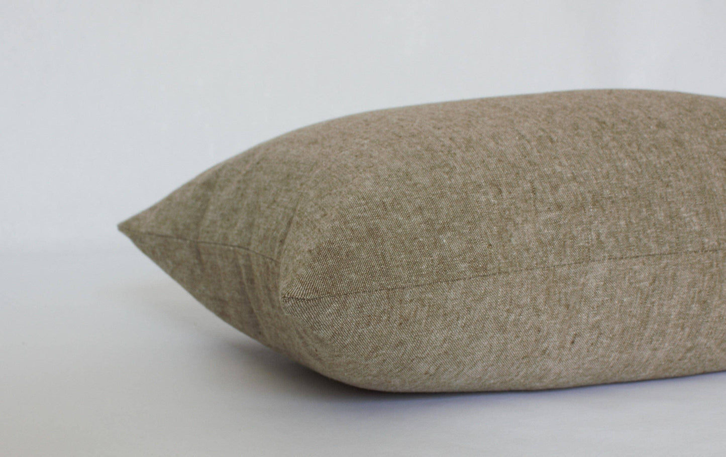 Beige linen decorative pillow on white background, soft texture, Come see us at Awaken, Franklin, Tennessee