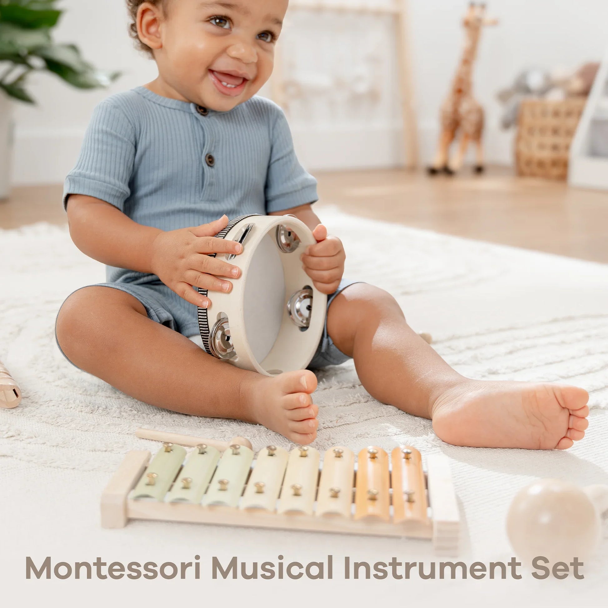 Smiling toddler playing tambourine, Montessori musical instrument set, Come see us at Awaken, Franklin, Tennessee.