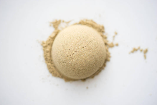 Close-up of a cracked tan powder mound on white surface, Come see us at Awaken, Franklin, Tennessee