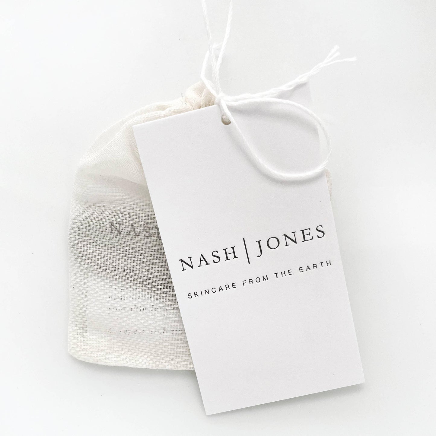 Nash Jones skincare tag on drawstring pouch, minimalist design, Come see us at Awaken, Franklin, Tennessee