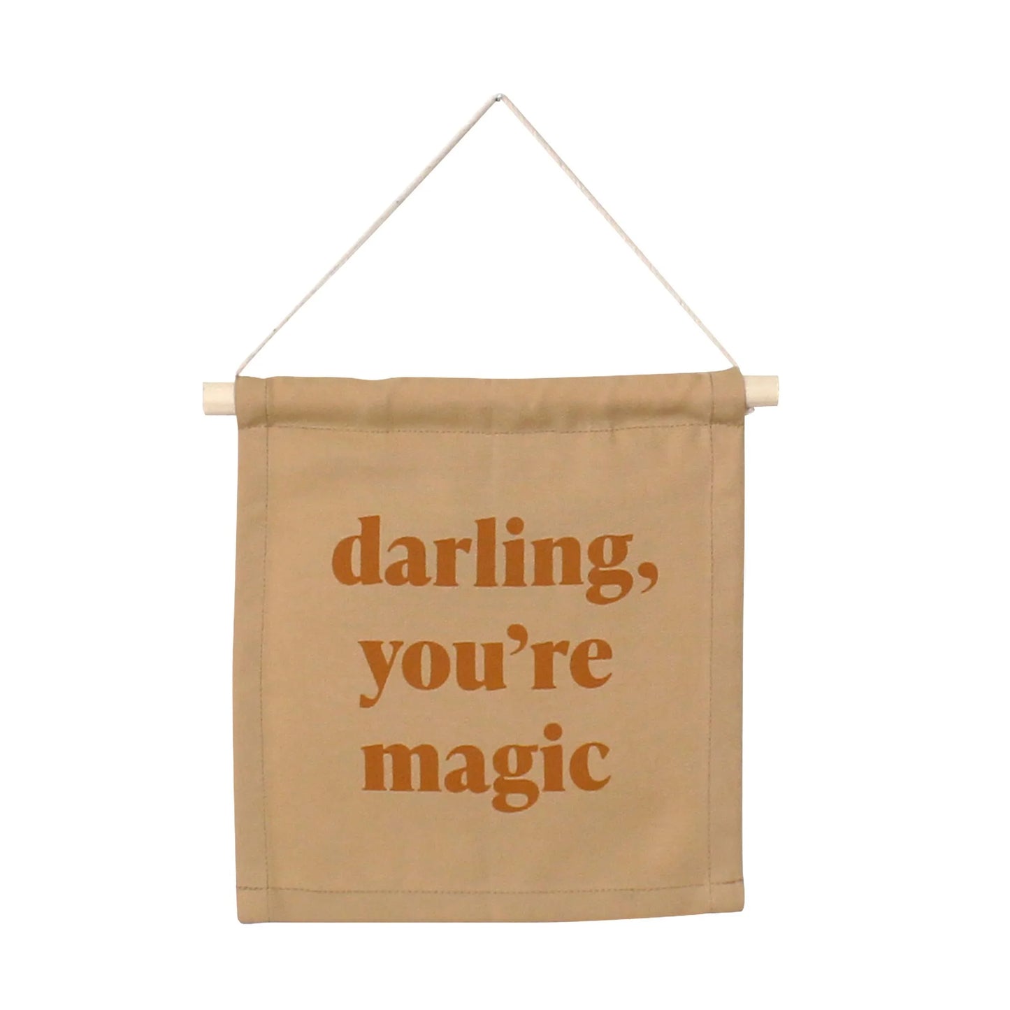 Tan fabric wall banner with 'darling, you're magic' text, Come see us at Awaken, Franklin, Tennessee.