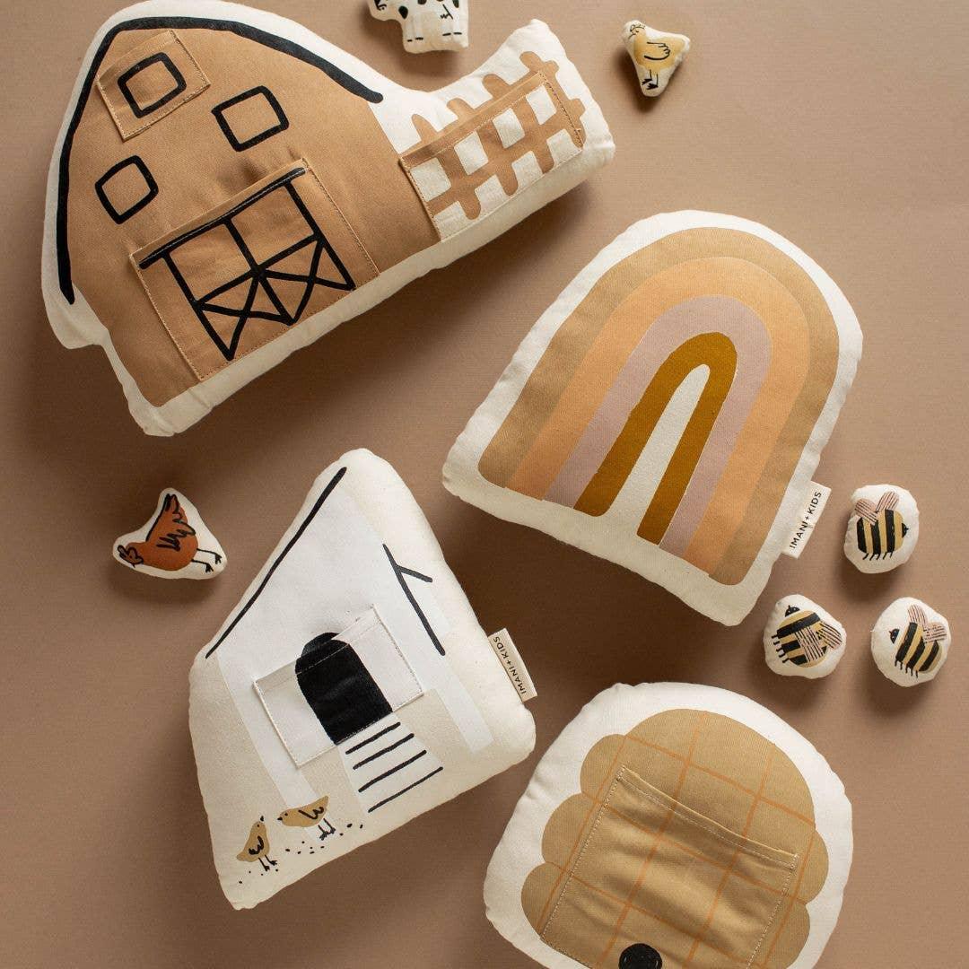 Farm-themed plush toys and animal pillows in neutral colors, Come see us at Awaken, Franklin, Tennessee