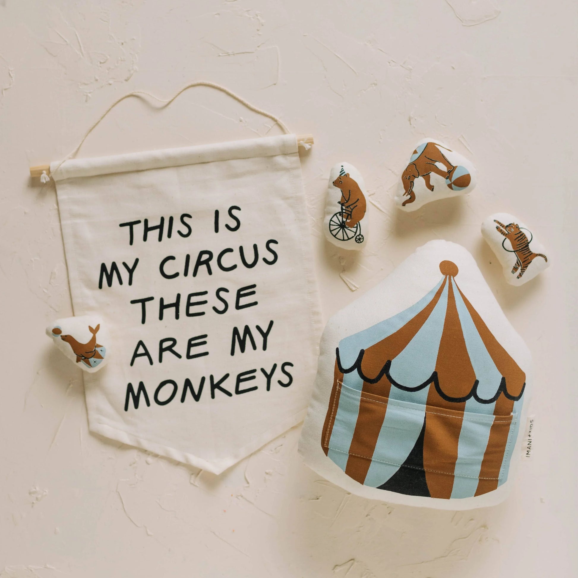 Circus-themed nursery decor with quote banner, plush animals, and tent. Come see us at Awaken, Franklin, Tennessee.