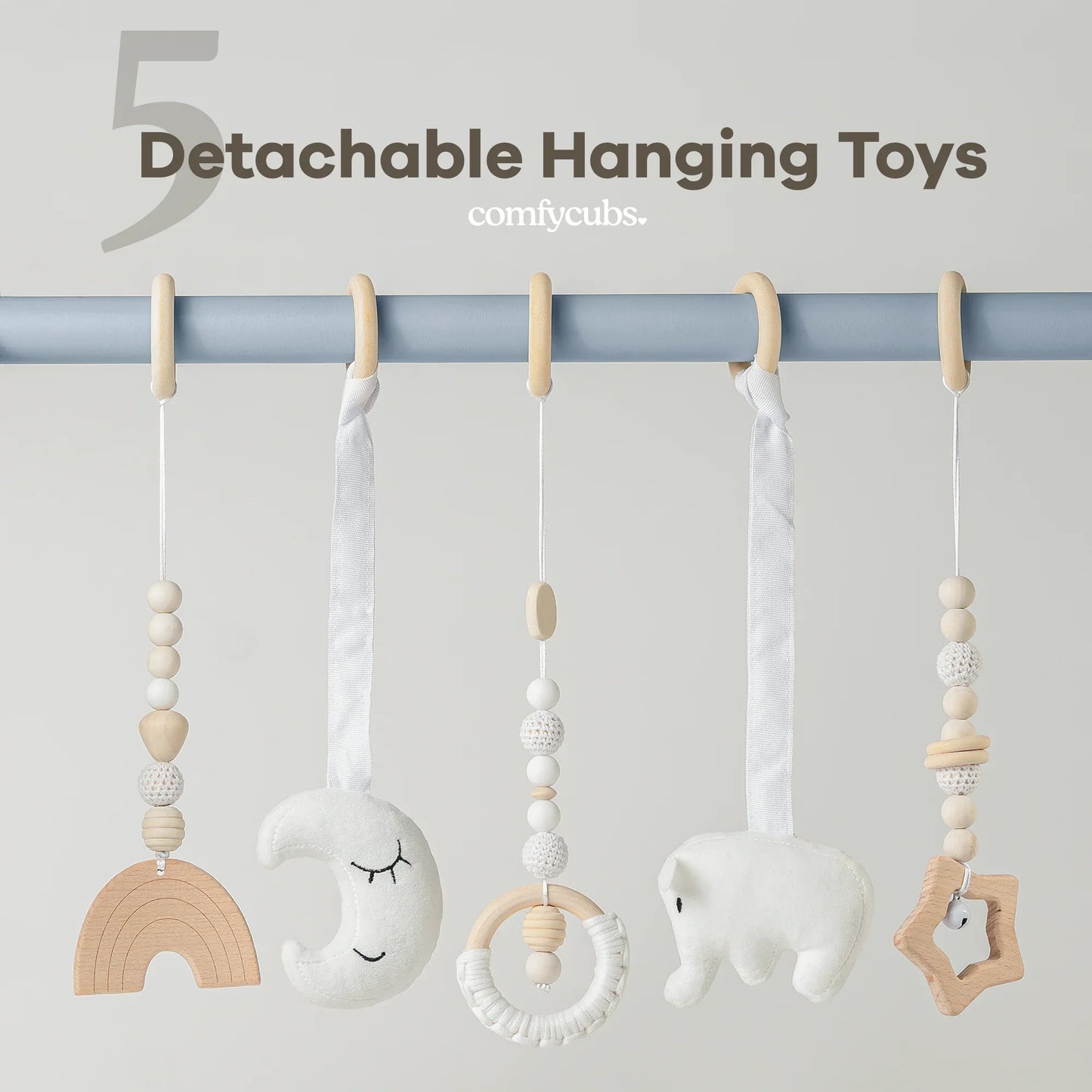 Set of five detachable hanging toys in neutral tones including wood beads, a moon, elephant, and star shapes. Come see us at Awaken, Franklin, Tennessee
