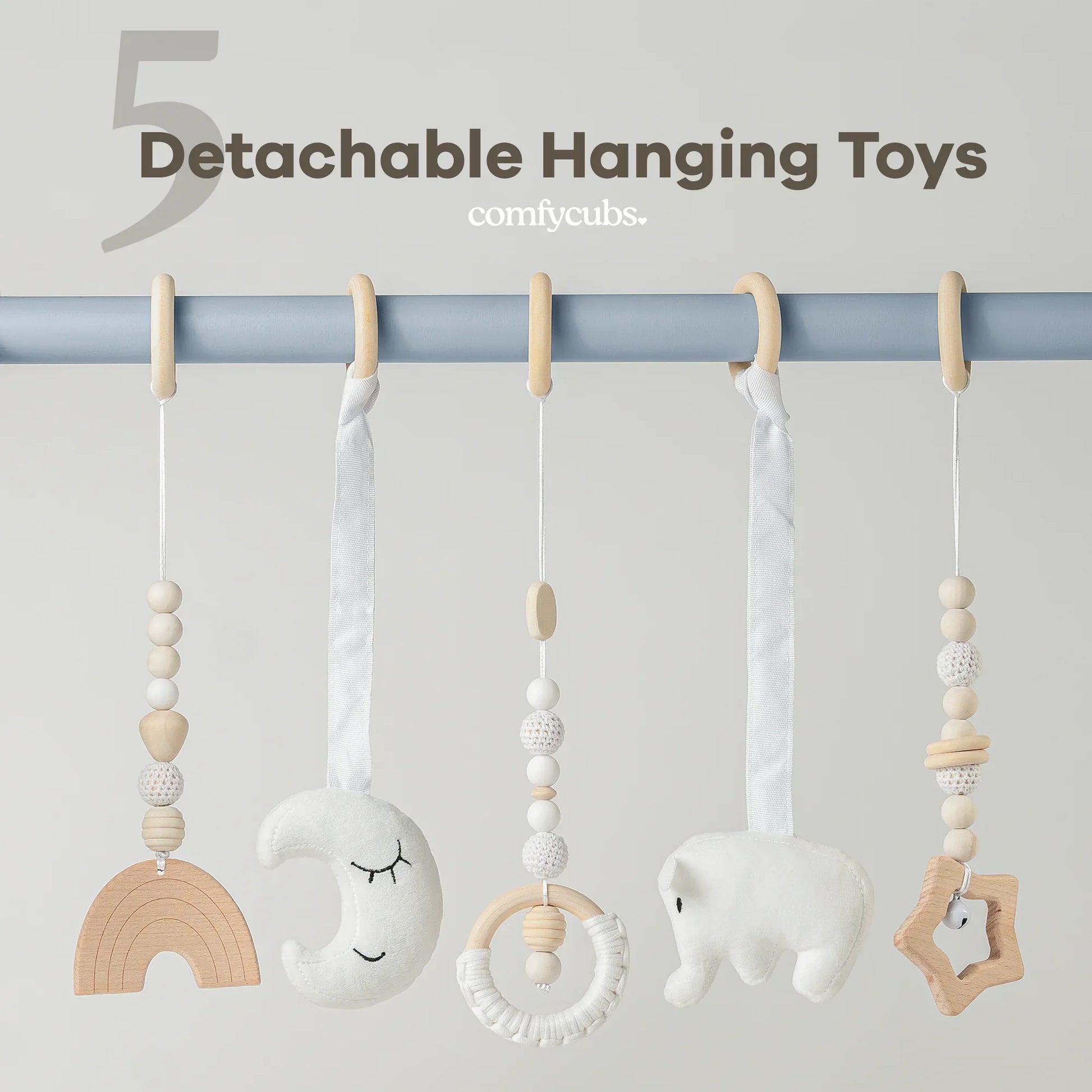 Set of five detachable hanging toys in neutral tones including wood beads, a moon, elephant, and star shapes. Come see us at Awaken, Franklin, Tennessee