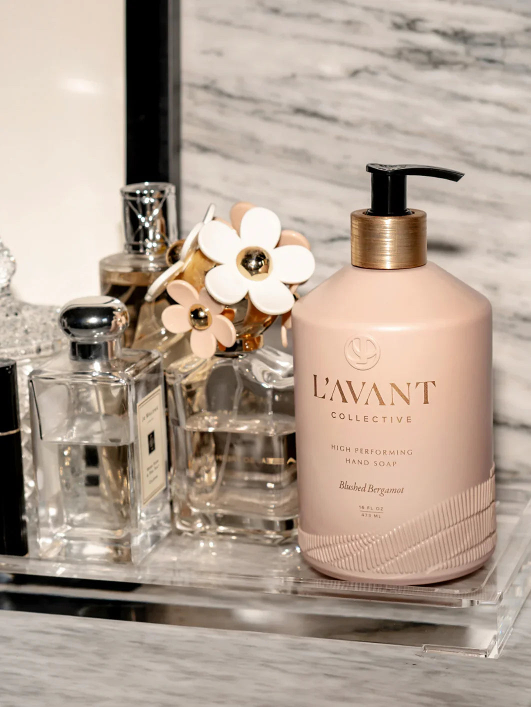 L'Avant Collective hand soap with perfume bottles on marble counter, Come see us at Awaken, Franklin, Tennessee