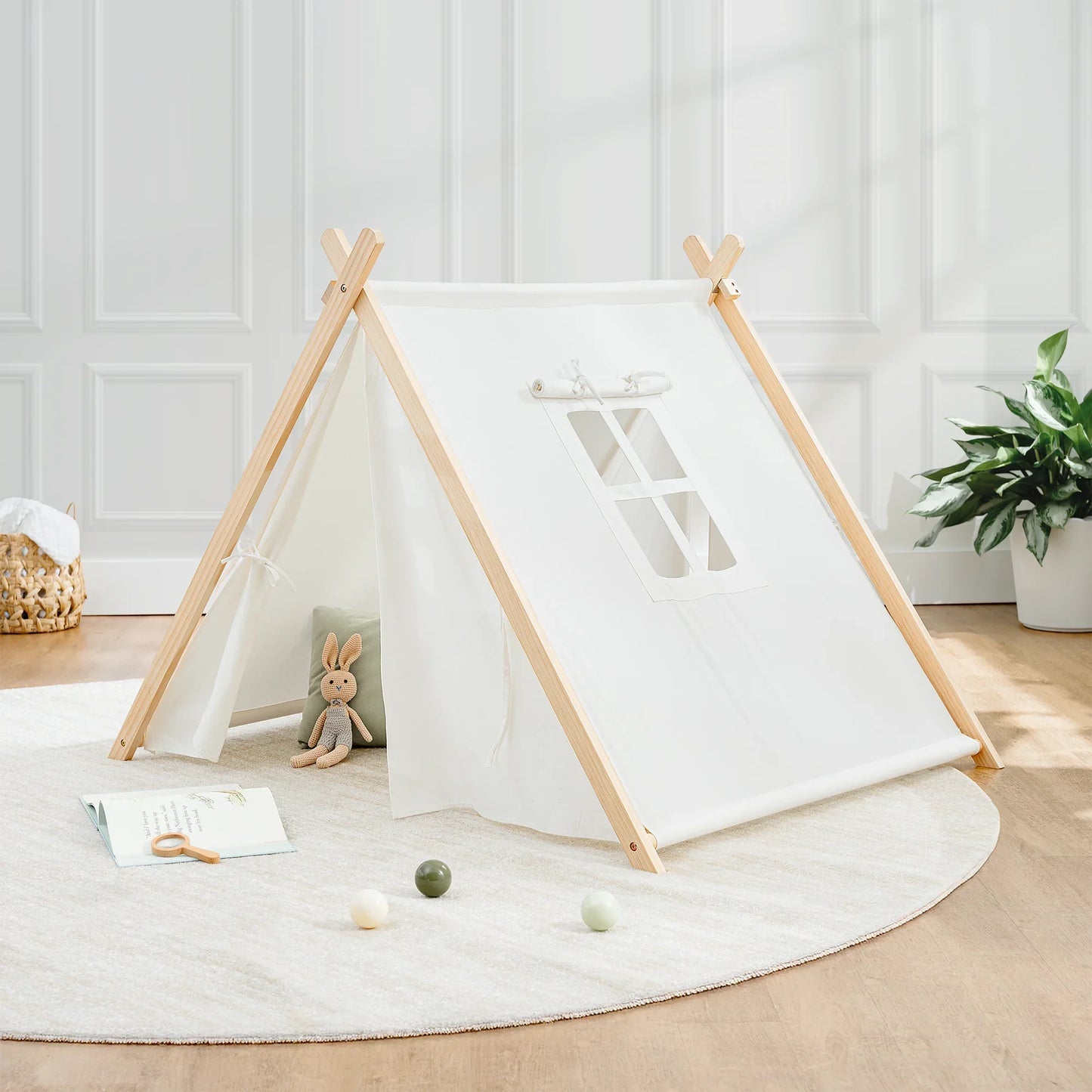 Kids play tent on round rug with plush bunny, toys, and plant; Come see us at Awaken, Franklin, Tennessee