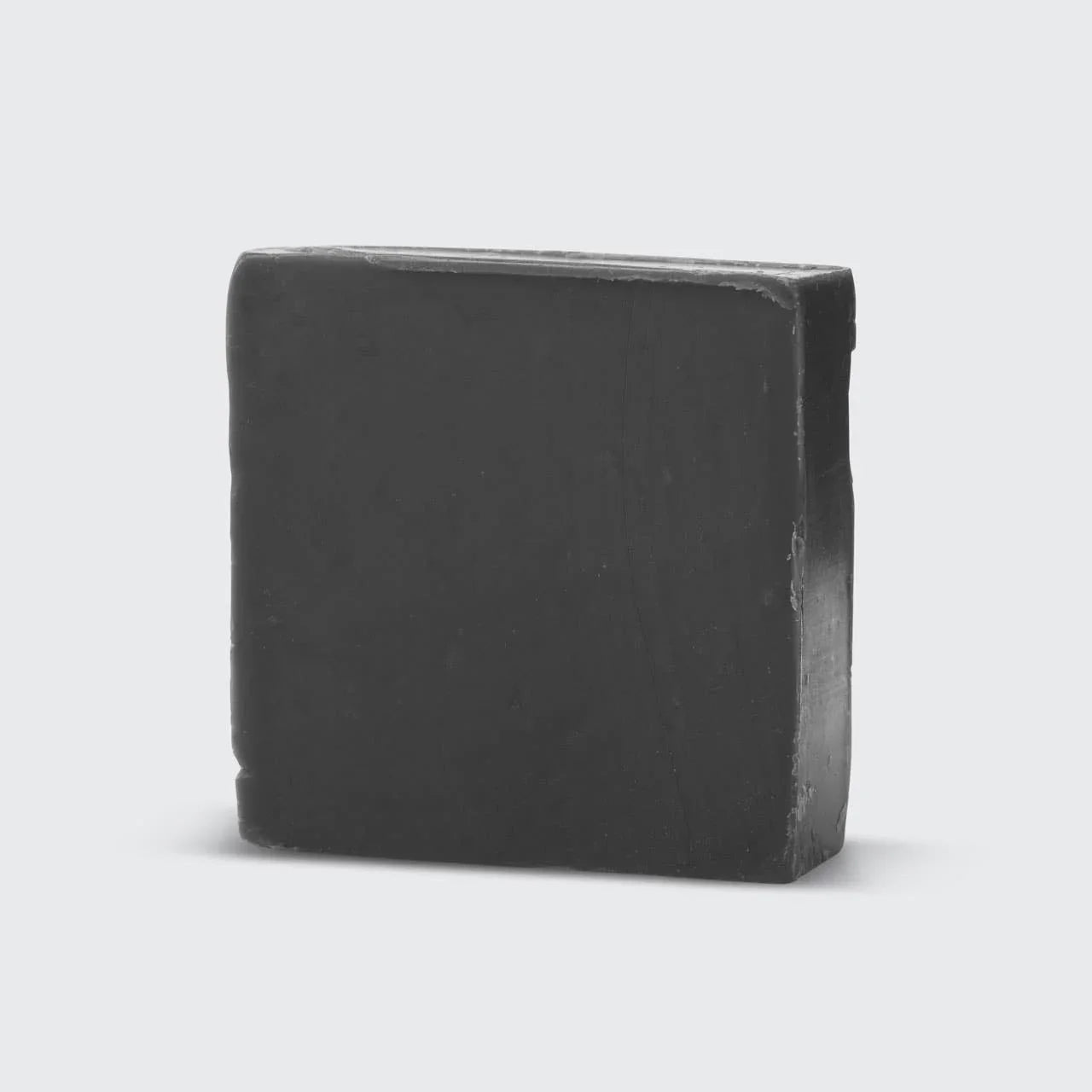 Black rectangular bar soap with smooth edges on white background. Come see us at Awaken, Franklin, Tennessee