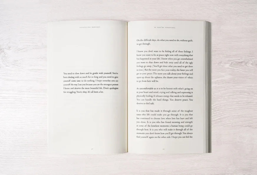 Open book with inspiring text on a light wooden surface, promoting self-care and healing. Come see us at Awaken, Franklin, Tennessee