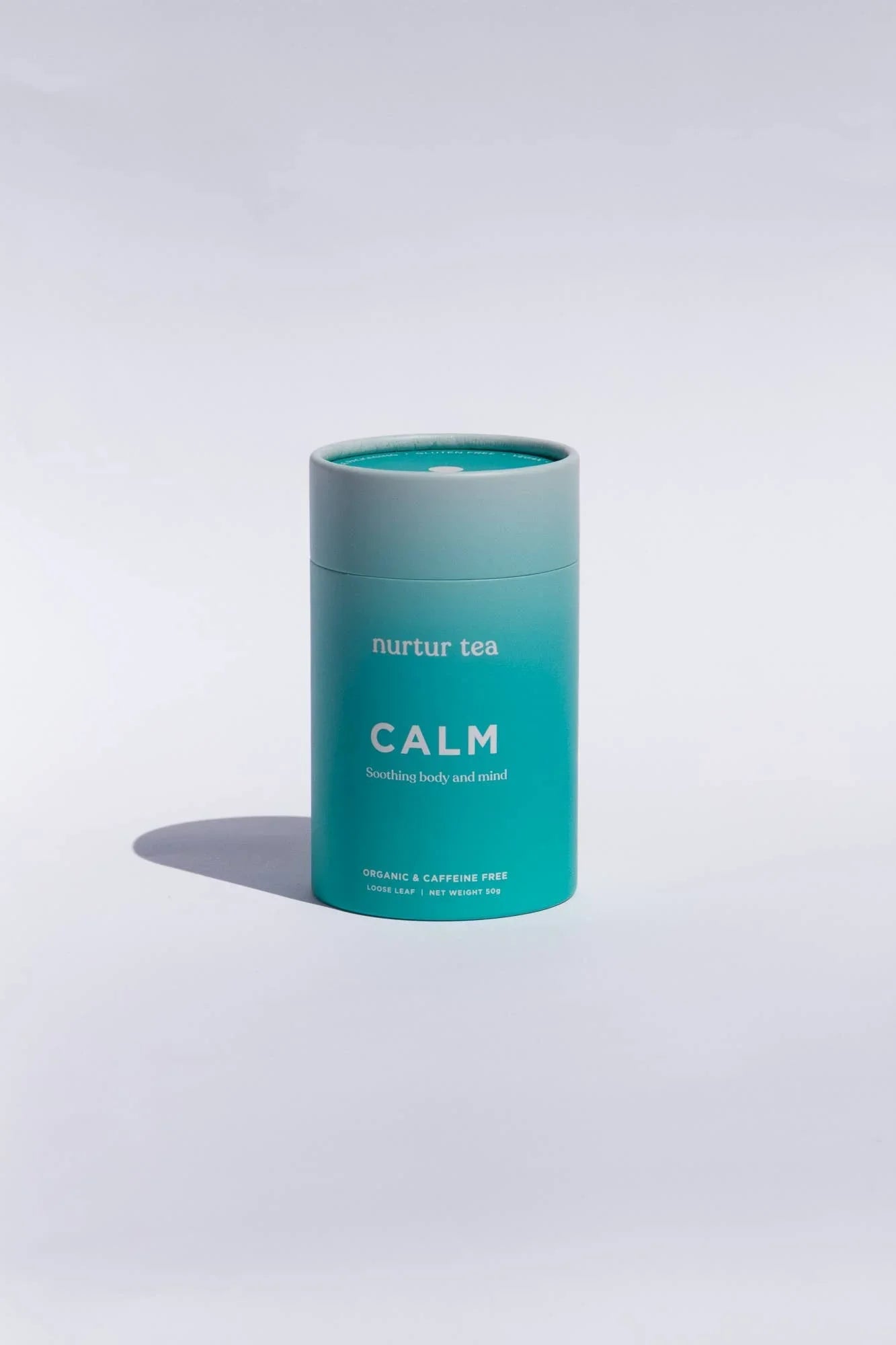 Nurtur Tea CALM organic, caffeine-free loose leaf tea in teal container on white background. Come see us at Awaken, Franklin, Tennessee