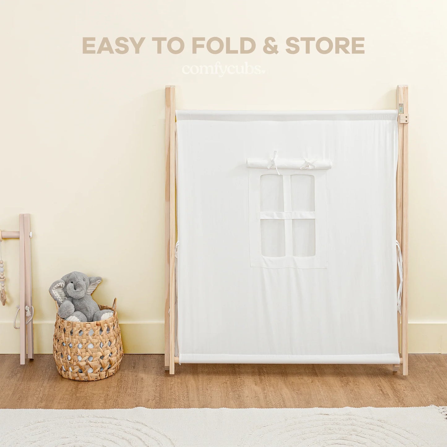 Easy to fold play tent with white fabric, wooden frame, and toy basket, Come see us at Awaken, Franklin, Tennessee