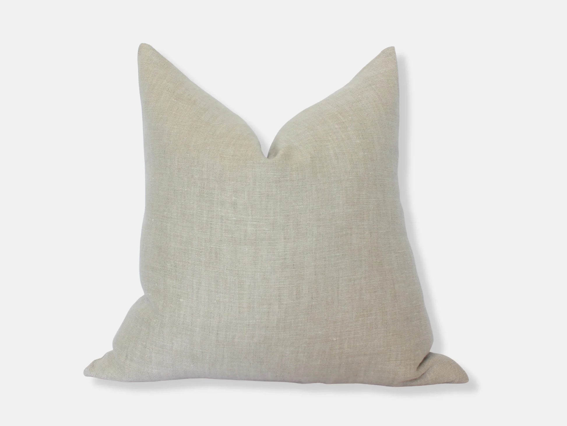 Beige linen square pillow with a soft texture on white background. Come see us at Awaken, Franklin, Tennessee